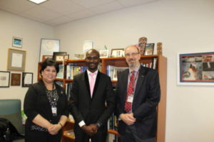 Runcie C.W. Chidebe, Executive Director of Project PINK BLUE (centre), with Dr. Oliver Bogler, Senior Vice President Academics Affairs (right), and Dr. Shubhra Ghosh, Project Director, Global Programs, UT MD Anderson Cancer Centre, Houston, Texas, USA. 